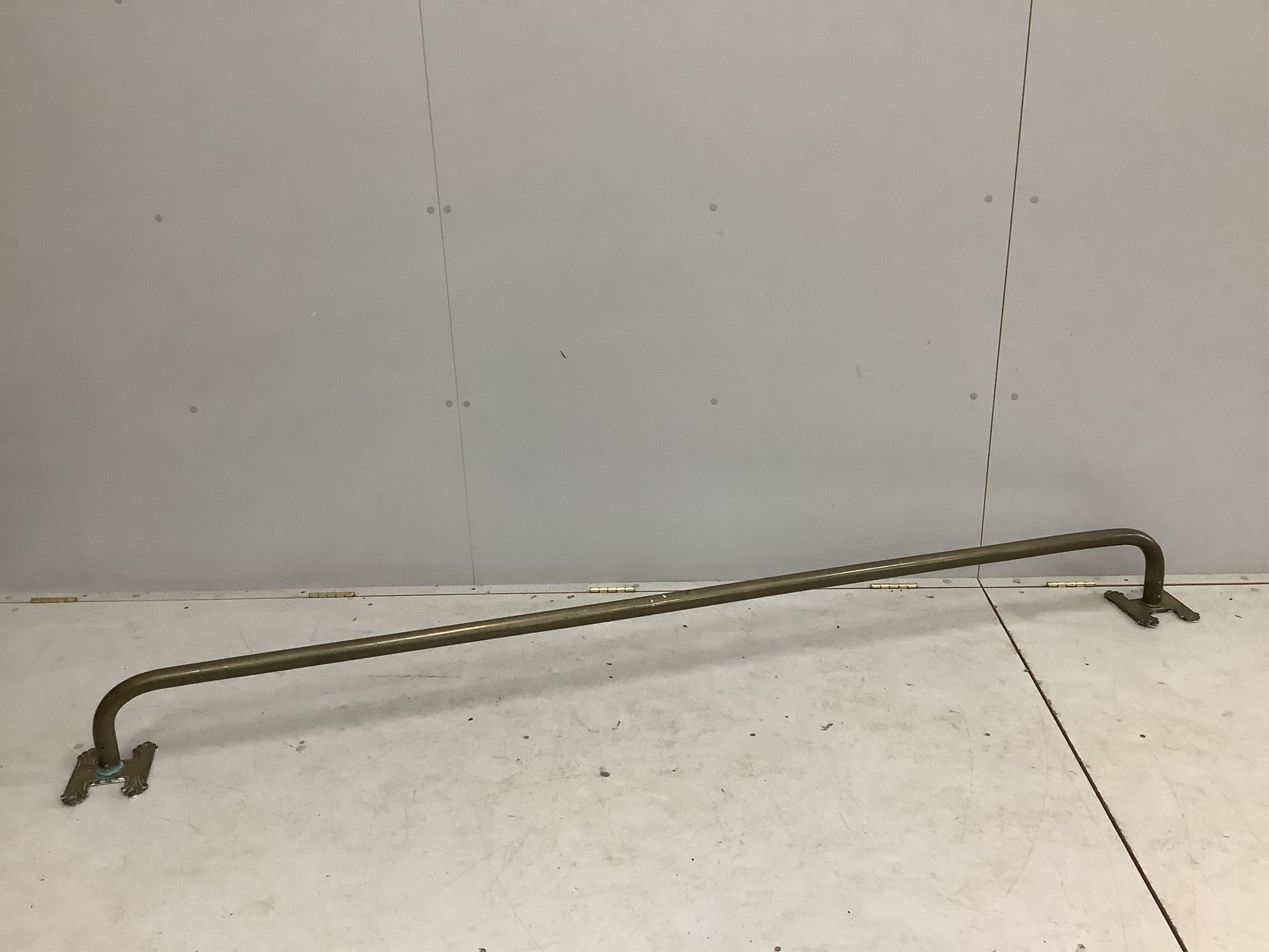 A late 19th century long brass rail by Dickson of Colchester, length 233cm. Condition - fair